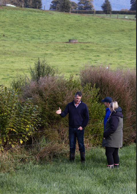 An environmental specialist advising farmers out in the paddock