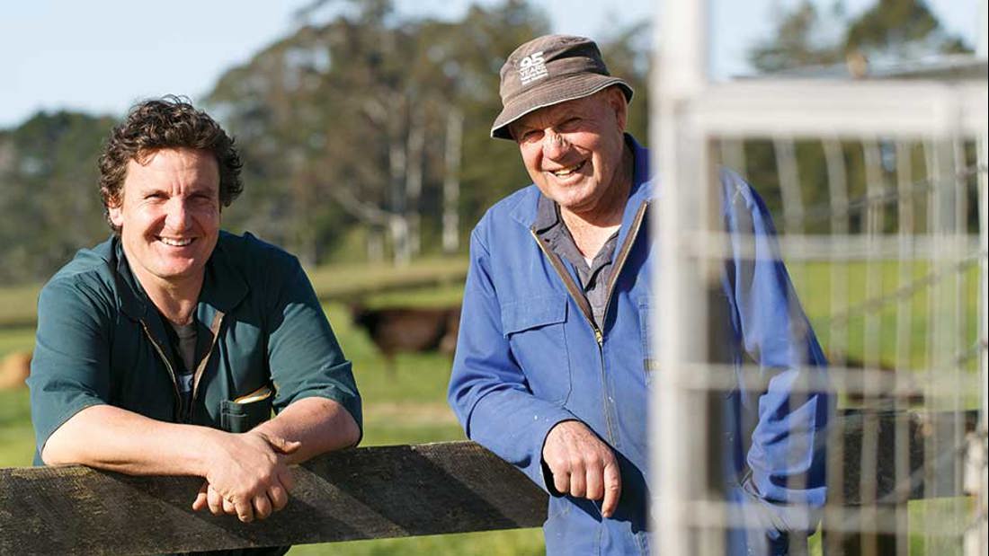 Two men standing together smiling