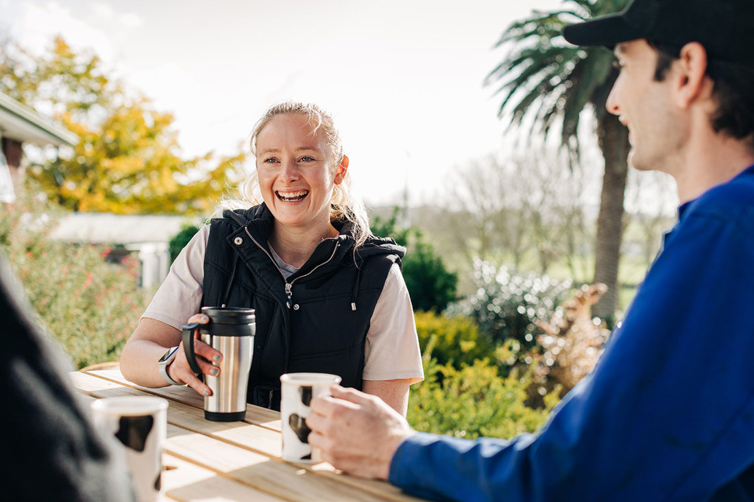 Farm employees enjoying a break together outside in the sunshine