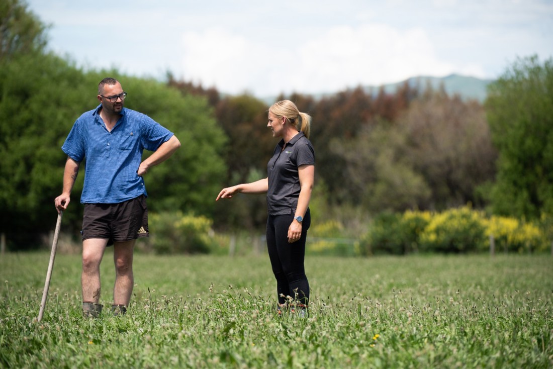 A DairyNZ regional team member discussing grazing with a dairy farmer