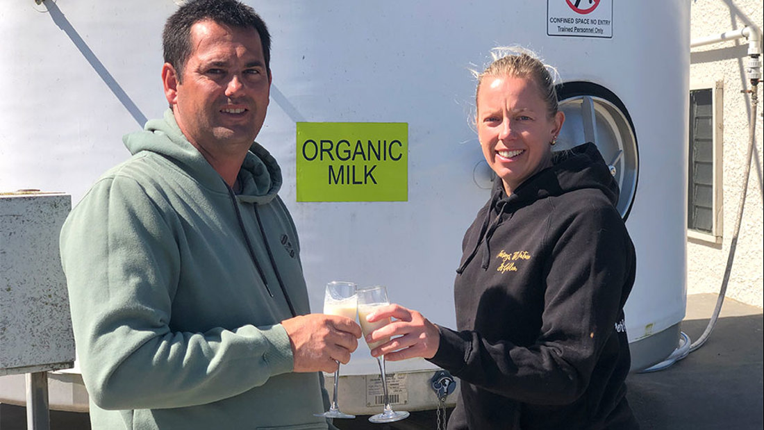 Two people toasting their glass of milk