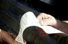 Close up focus of individuals checking on an invoice slip regarding purchase details